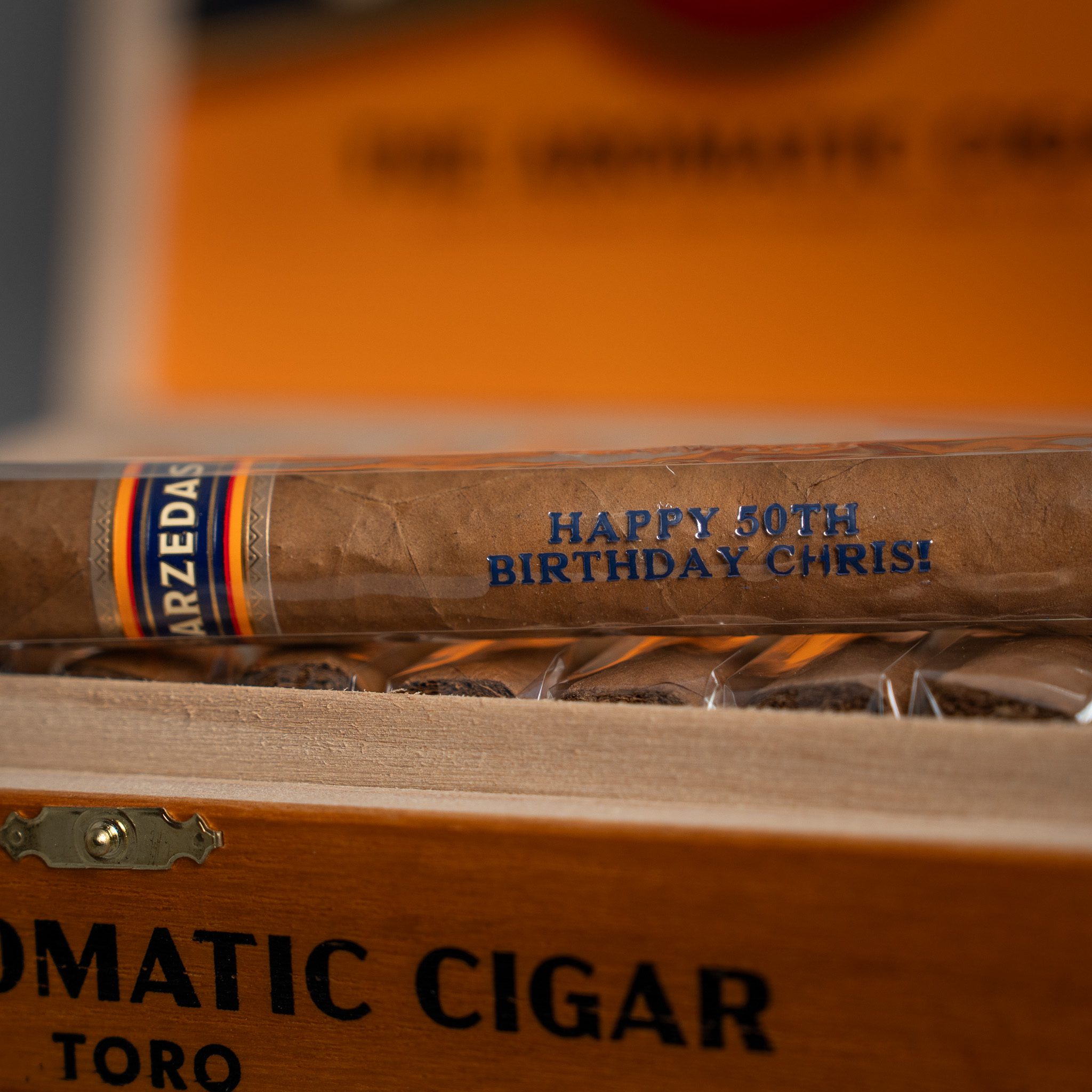 Close up of a single cigar with personalized cigar cellophane
