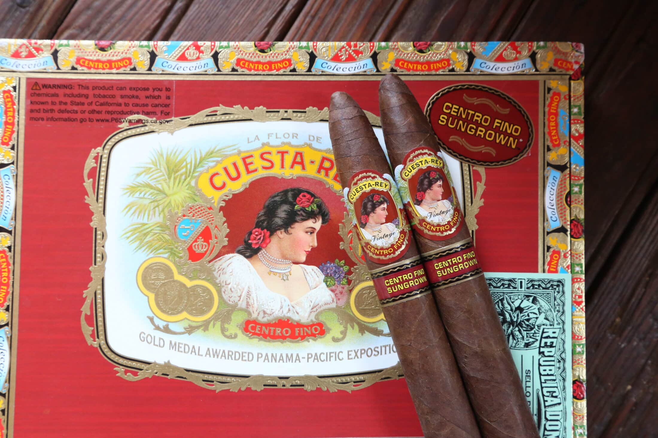 Two Cuesta-Rey Centro Fino Single Cigars laying on closed box