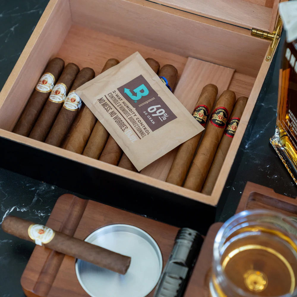 Boveda 60 Gram 69% RH Pack atop a variety of cigars in an open humidor